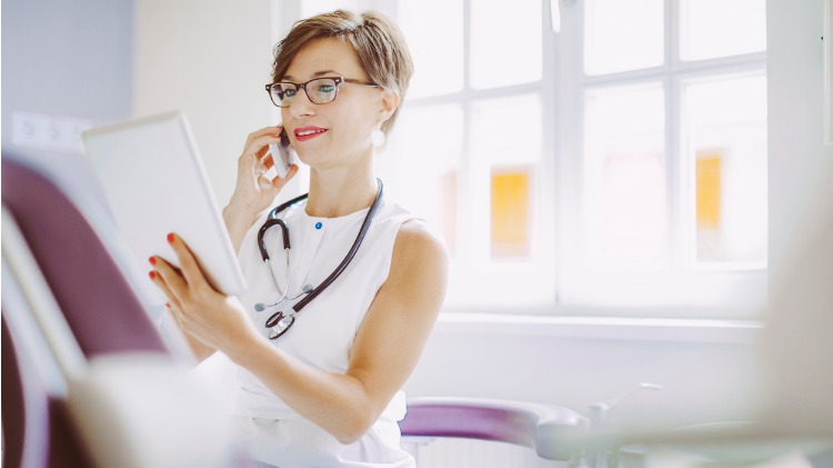 Doctor looking at information while on the phone