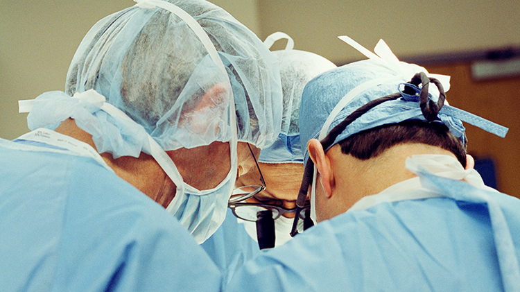 Close-up of three surgeons heads