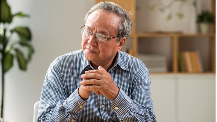 Seated man looks contemplative