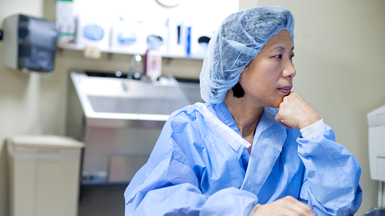 Contemplative doctor in scrubs