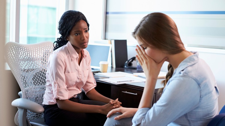 Doctor in consultation with upset patient