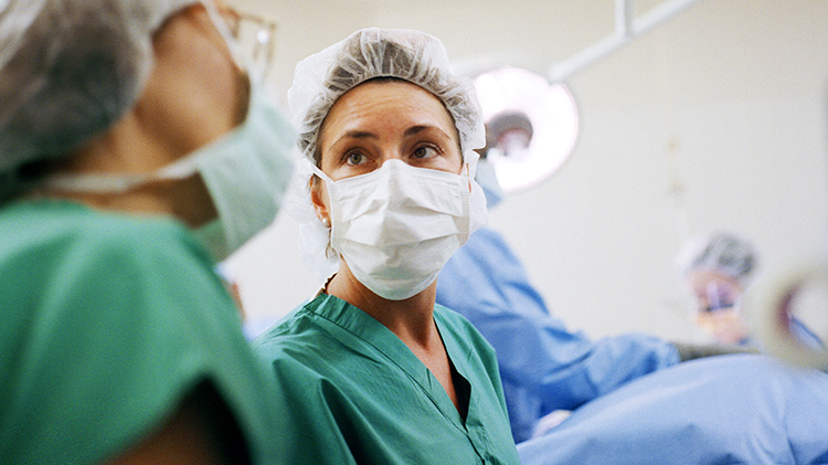 Doctors confer in surgical masks
