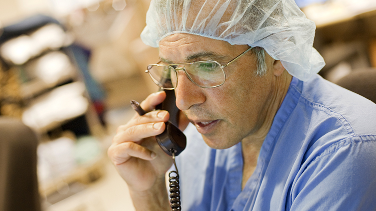 Doctor in scrubs on the phone