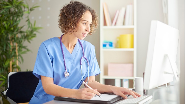 Doctor sitting at her computer