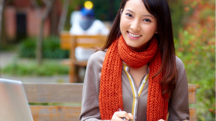 Student with text books smiling