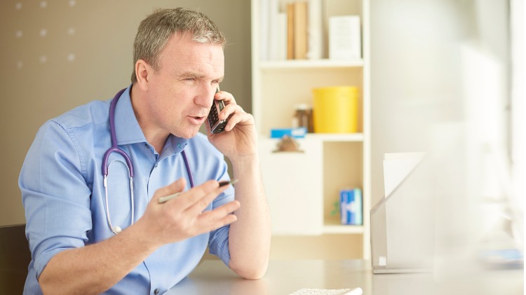 Male doctor on the phone