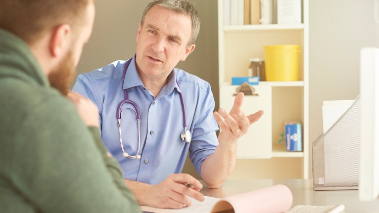 Doctor speaking to male patient