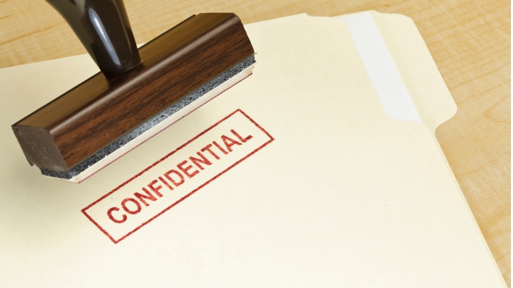 Folder being stamped CONFIDENTIAL