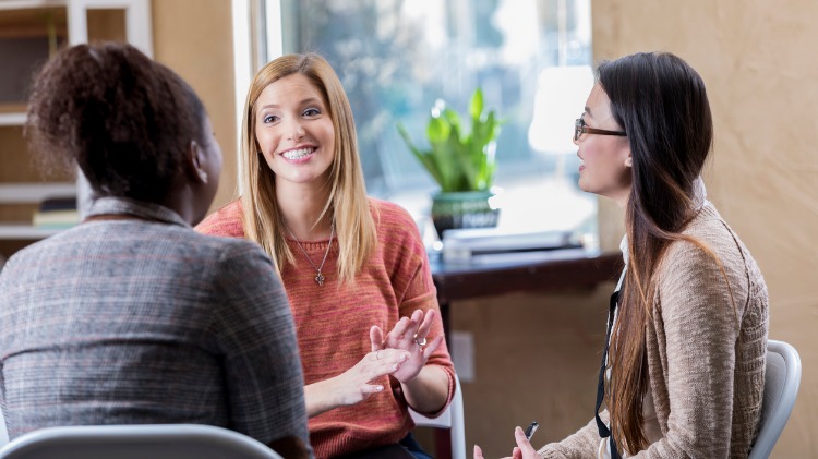 Positive conversation between three women