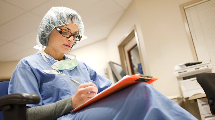 Seated hospital Dr with clipboard