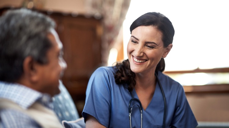 Kind female doctor smiles at male colleague/patient