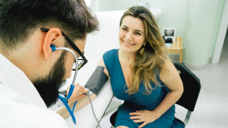 Young male doctor with adoring looking female patient