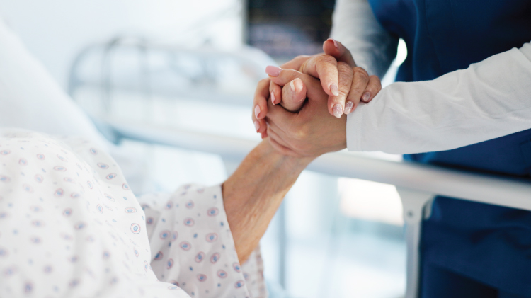 Doctor holding patient's hand