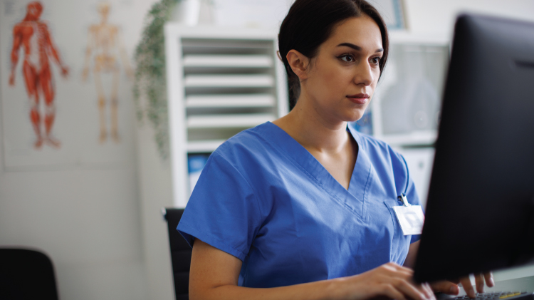 Image of doctor typing on computer